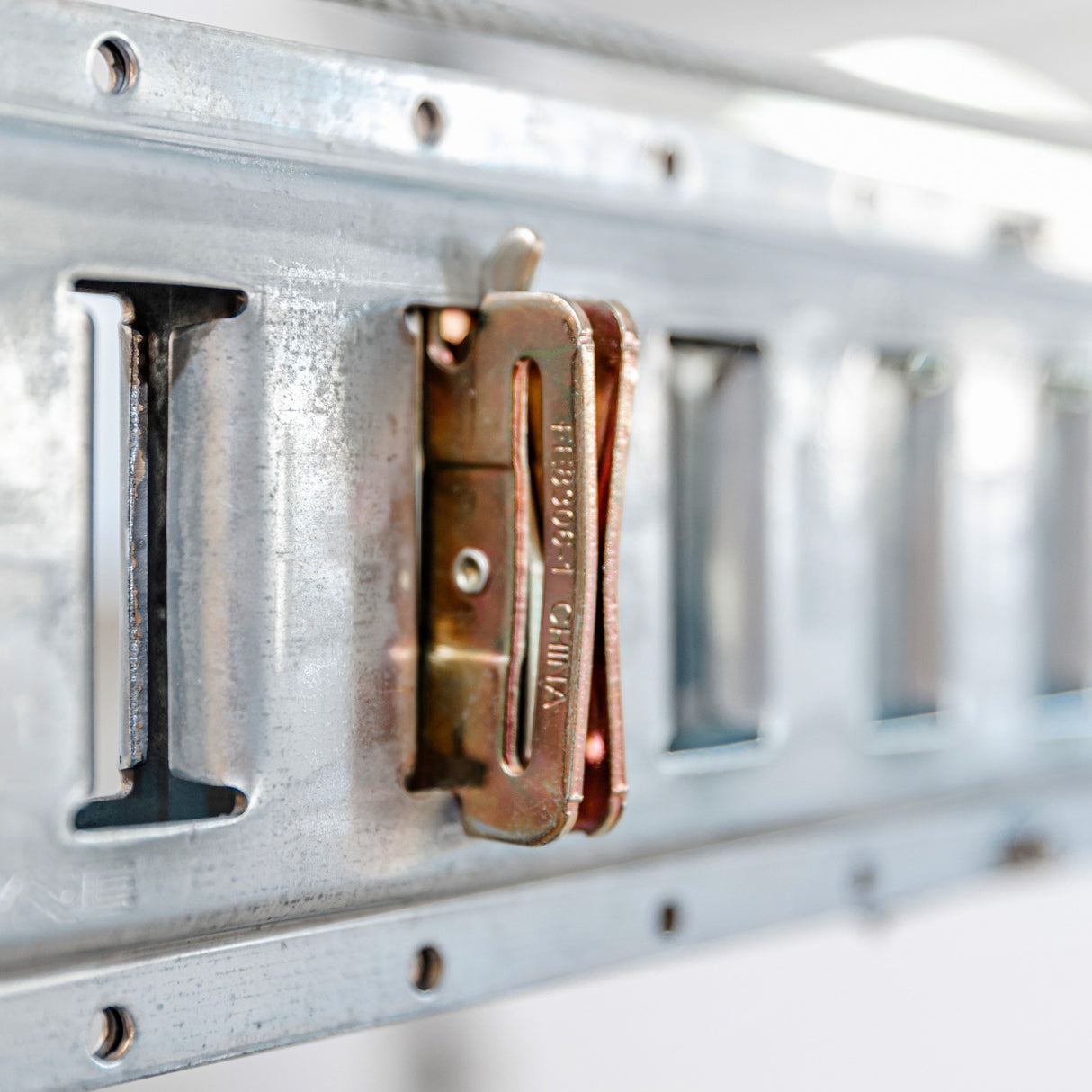 Close-up of a wall-mounted bracket on a lift for the garage, emphasizing practical and efficient storage solutions.