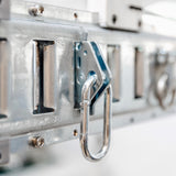Close-up of a metal hook on an overhead garage storage rack, part of essential accessories.