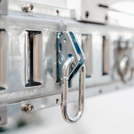 Close-up of a metal hook on an overhead garage storage rack, part of essential accessories.