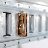 Close-up of a wall-mounted bracket on a lift for the garage, emphasizing practical and efficient storage solutions.