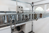 Organized garage with a wall-mounted lift storage system, featuring hooks and shelves for storage.