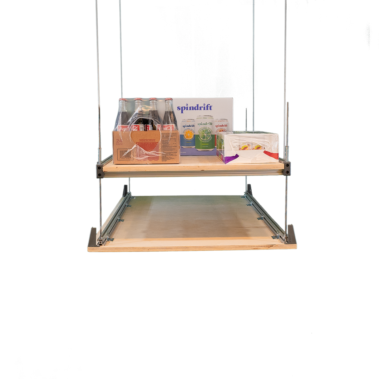 Attic storage lift system with shelves holding boxes and supplies, demonstrating convenient overhead storage for the garage.