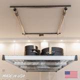 Garage storage platform holding cases, demonstrating a motorized lift system for efficient overhead storage, made in the USA.