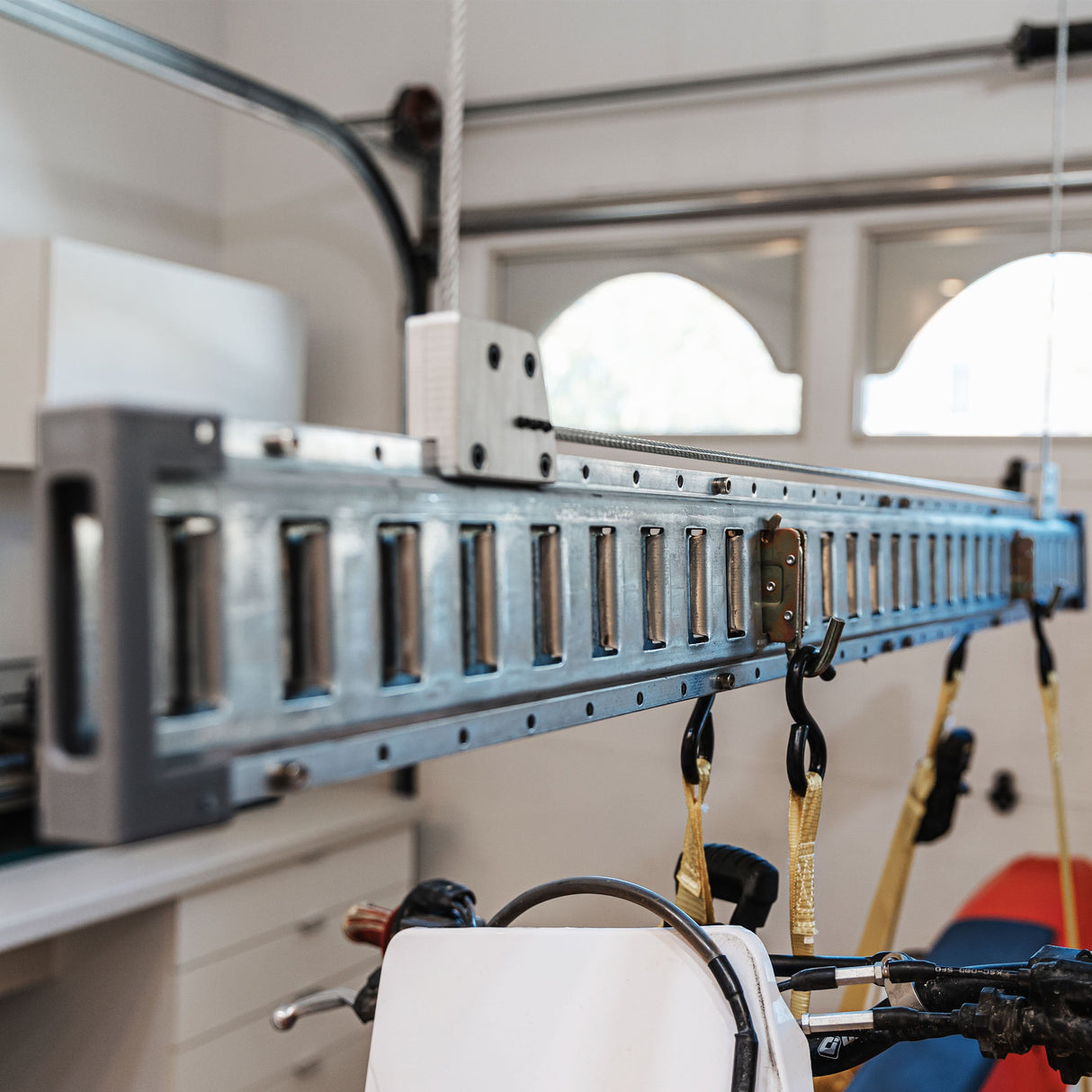 Close-up of a setup with a bike lift for the garage, highlighting secure and organized storage for a motorbike.