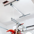 Garage ceiling with a bike lift for the garage, showcasing a motorbike securely suspended and organized overhead.