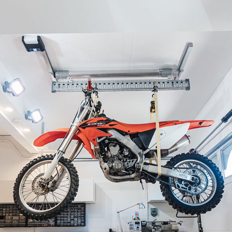 Motorbike hoisted using a bike lift for the garage, demonstrating an efficient storage solution.